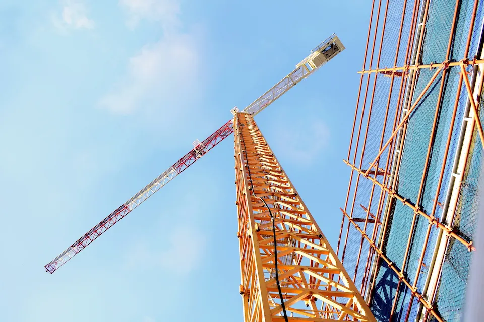 Tower crane and high-rise scaffolding system coordinated by Ontario Scaffolding on a large commercial construction site.