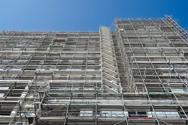 Multi-level building fully wrapped in steel scaffolding erected by Ontario Scaffolding for full exterior construction access.