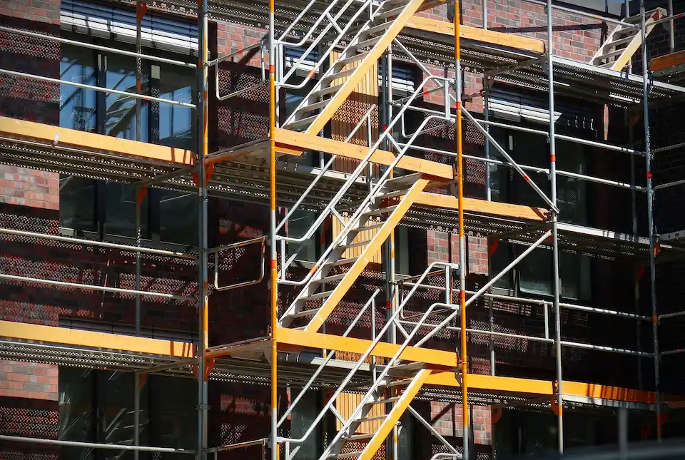 Metal scaffold stair tower and platform access system on commercial brick building by Ontario Scaffolding