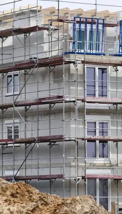 Multi-story residential building under construction with full exterior scaffold system by Ontario Scaffolding